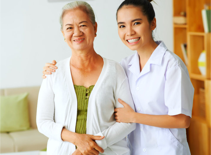 caregiver assisting senior man to stand