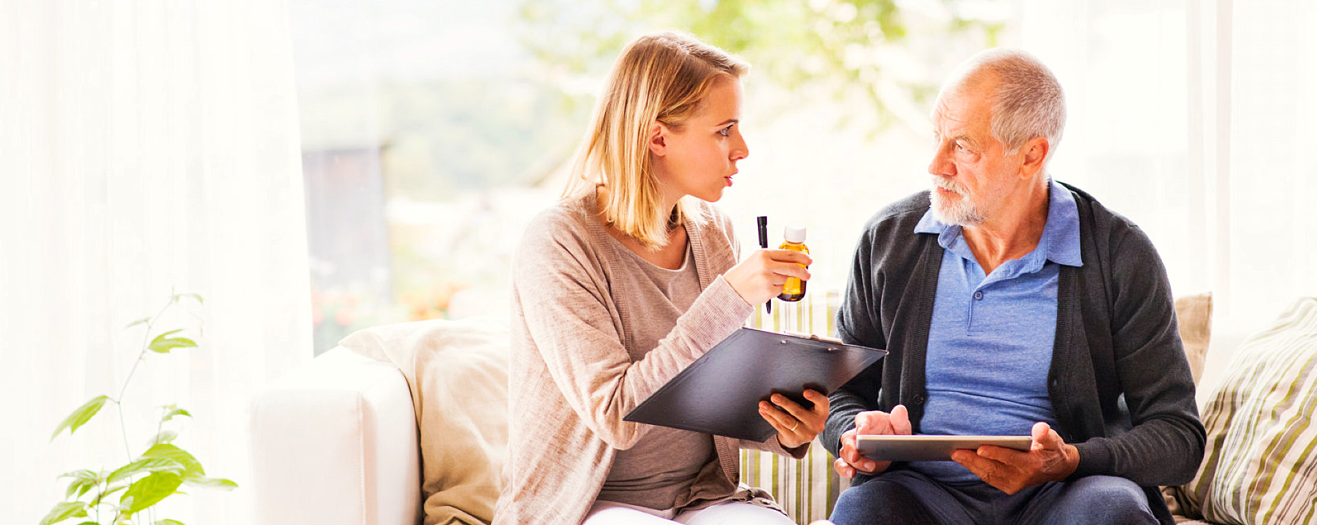 caregiver and elder man talking