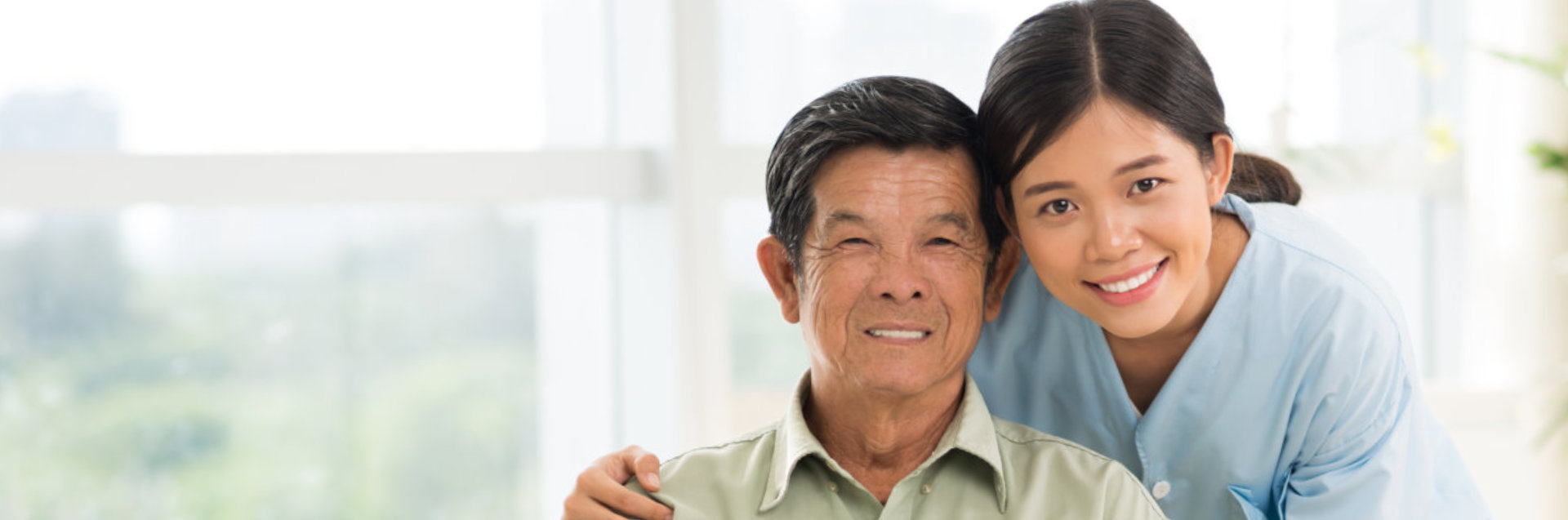 lady caregiver and old man smiling