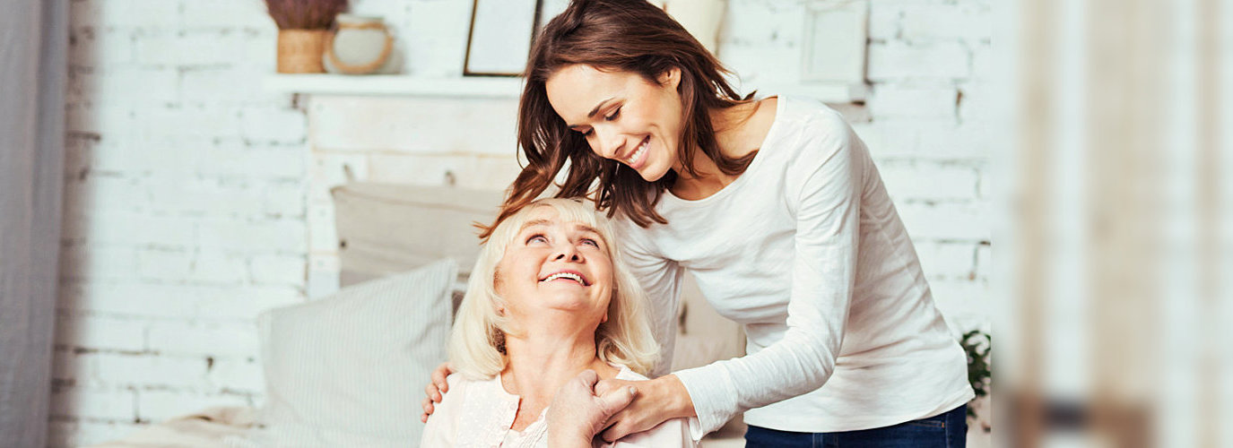 caregiver and senior woman looking at each other